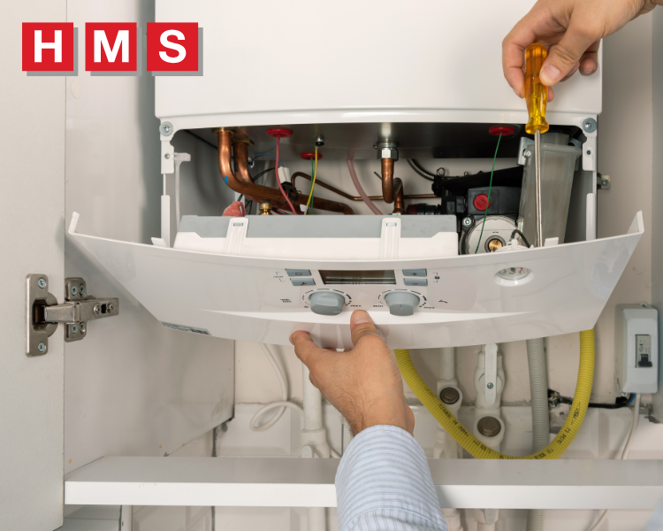 An engineer servicing a boiler in Droitwich